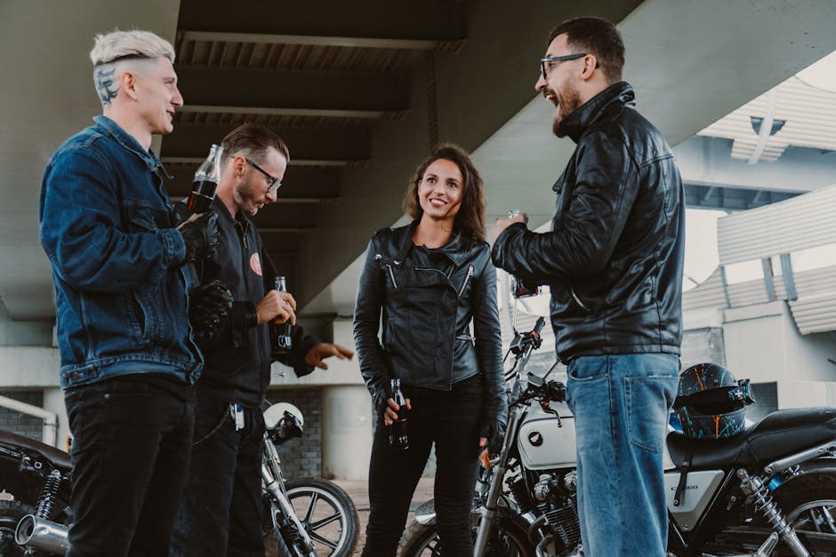 Casual gathering of friends under a bridge with motorcycles, sharing drinks and conversation.