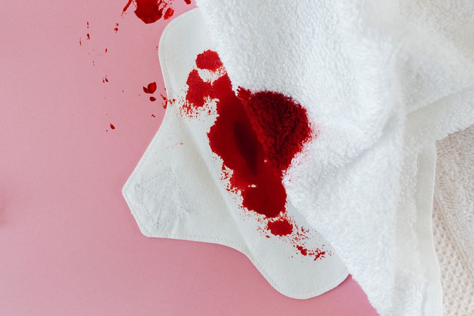 Close-up of a sanitary pad with blood stains, illustrating menstruation and period care.